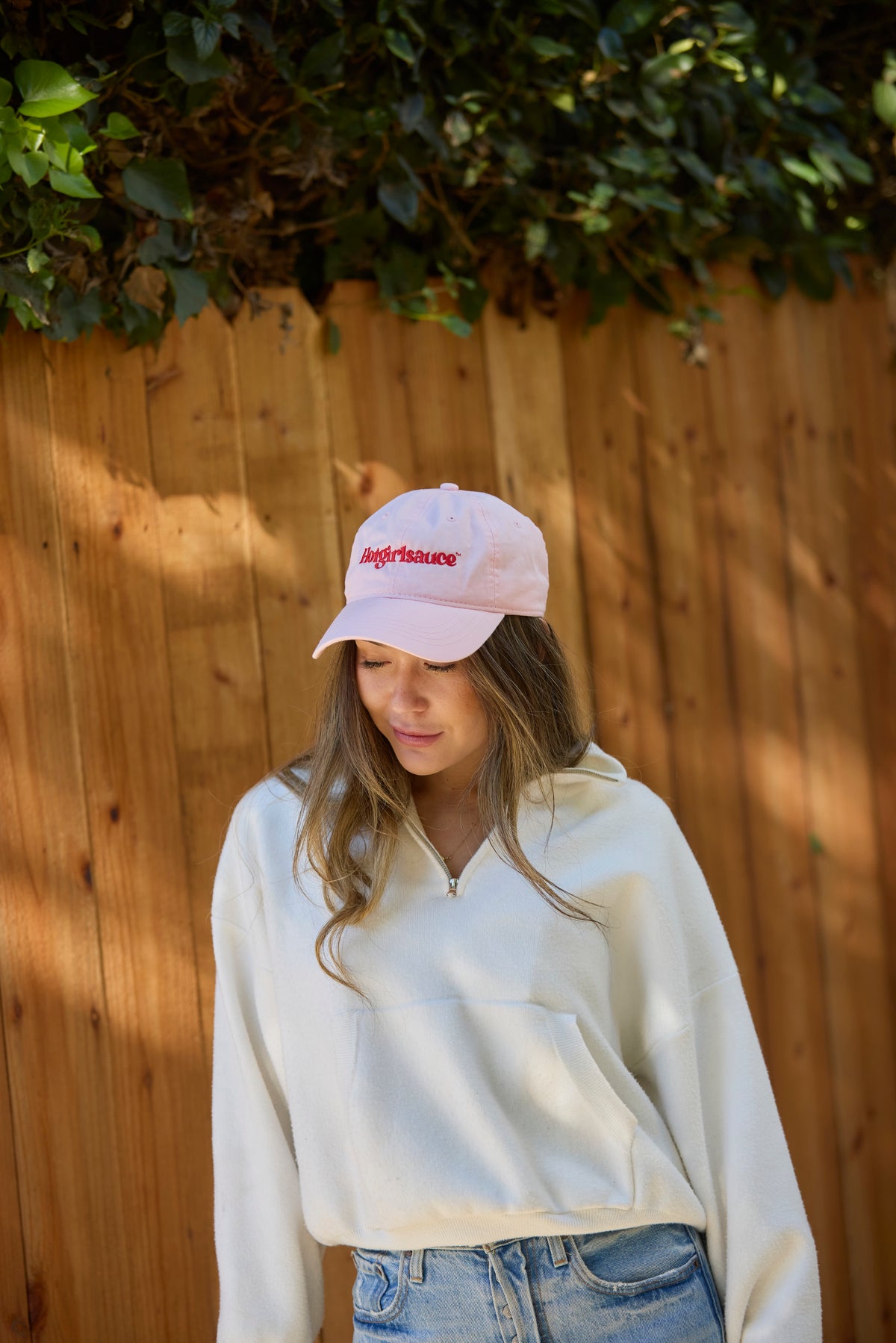 Model wearing blush pink Hotgirlsauce hat with casual outfit outdoors